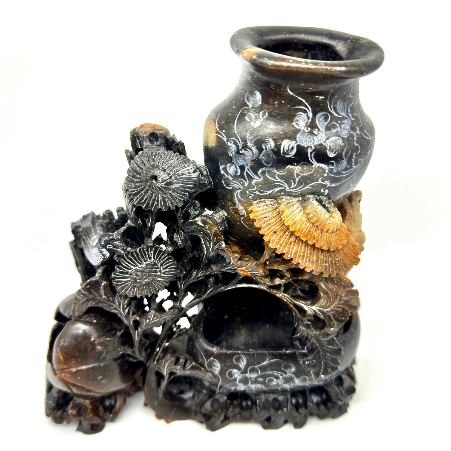 Hand-carved soapstone twin vessel sculpture with birds, flowers, and golden leaf details on dark stone base