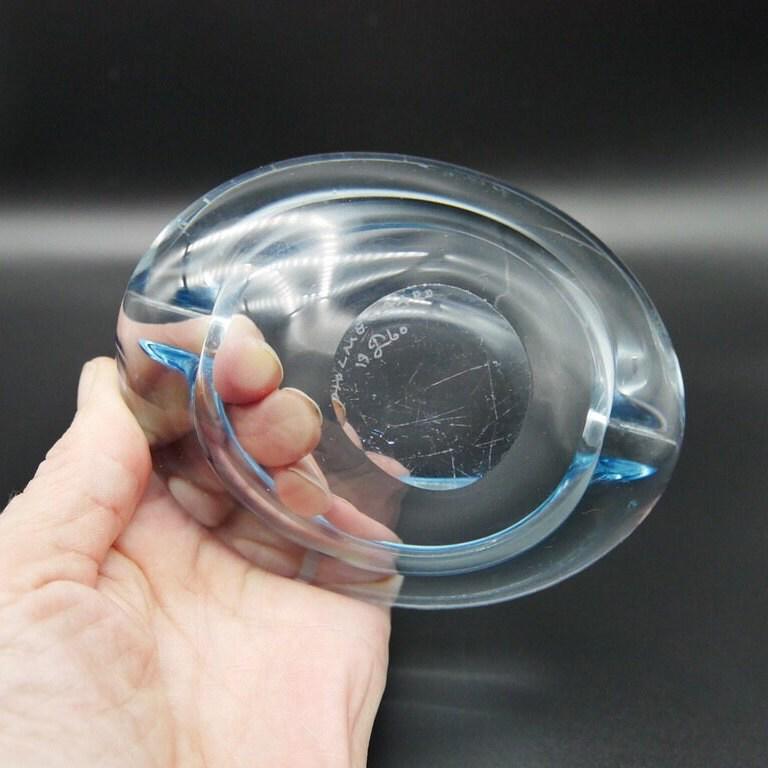 Hand holding Holmegaard ice-blue crystal bowl showing scale, weight, and petite size relative to palm