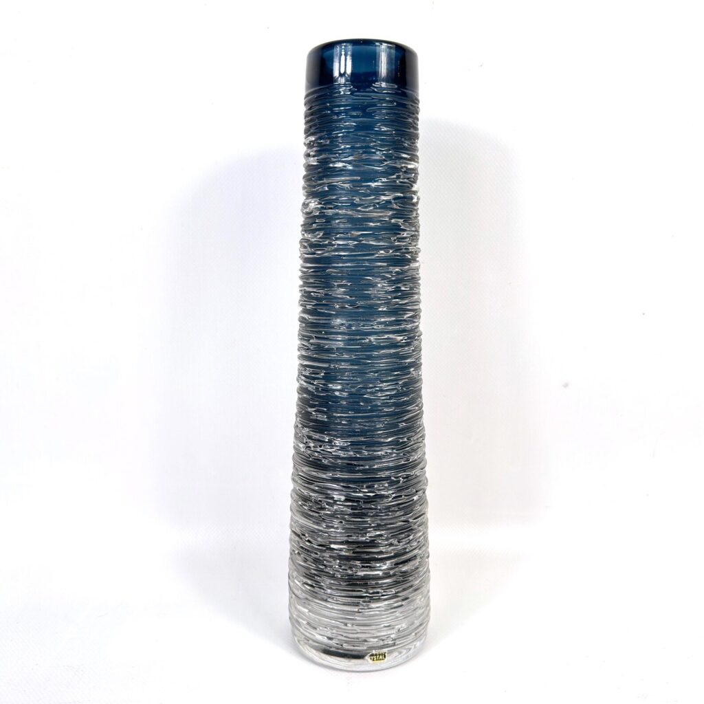 Tall cylindrical glass vase with horizontal linear texture creating striped effect in blue and silver tones.