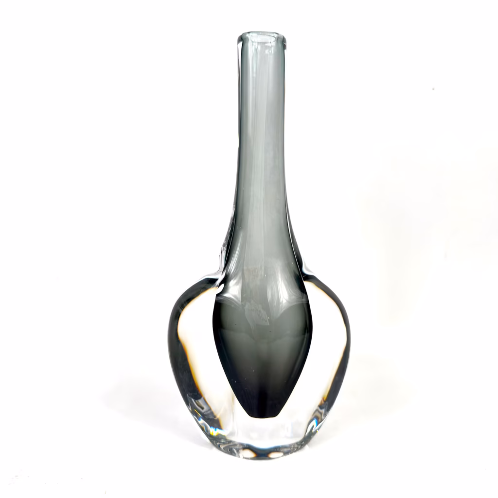 Slender glass vessel with pale blue gradient, narrow opening and elongated form suggesting elegant simplicity.