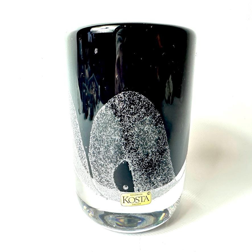 Kosta Boda vase front view with gold maker's label visible, black body with white bubble pattern and open rim