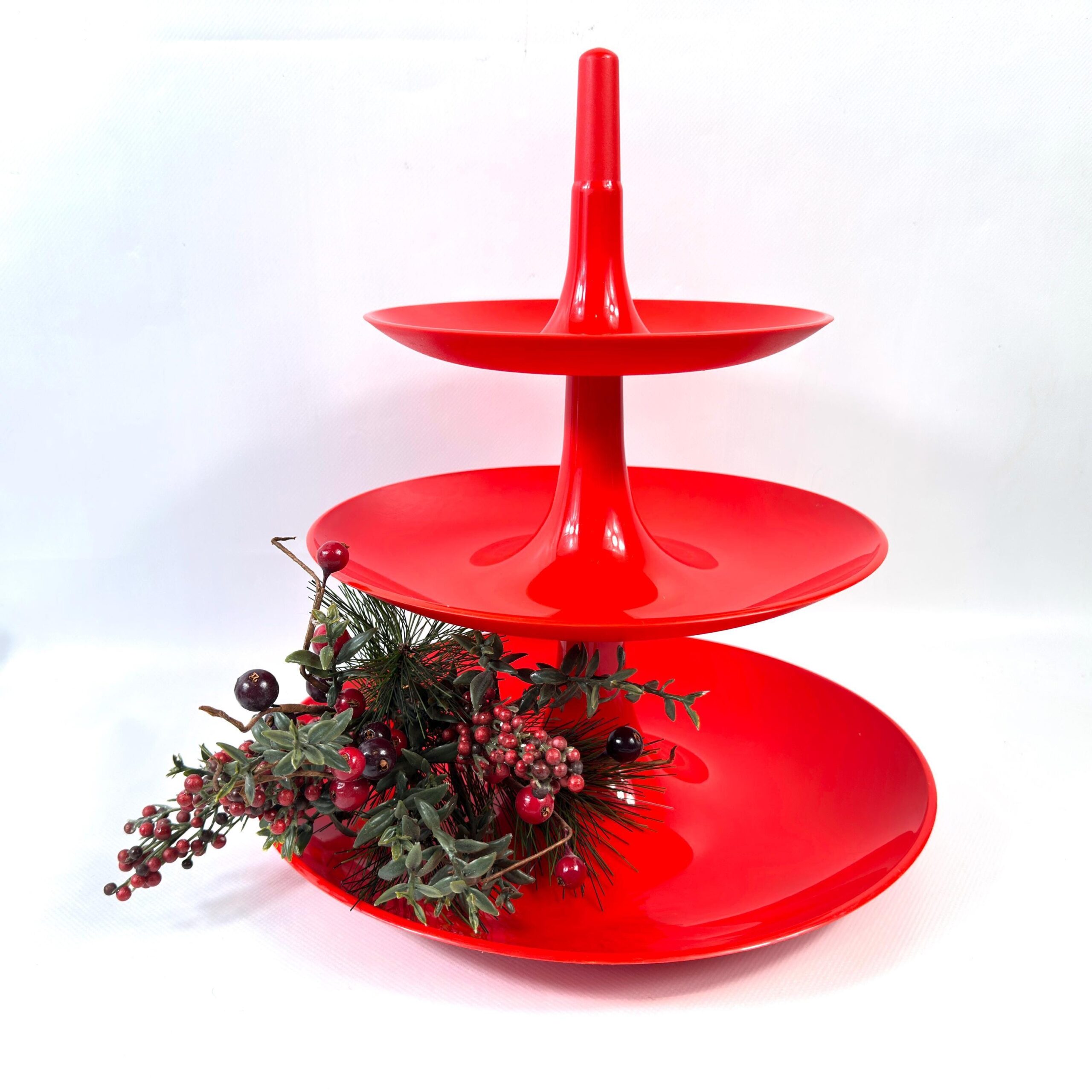 Koziol red three-tier serving stand with detachable plates, modernist German design from 1997, displayed with festive floral 