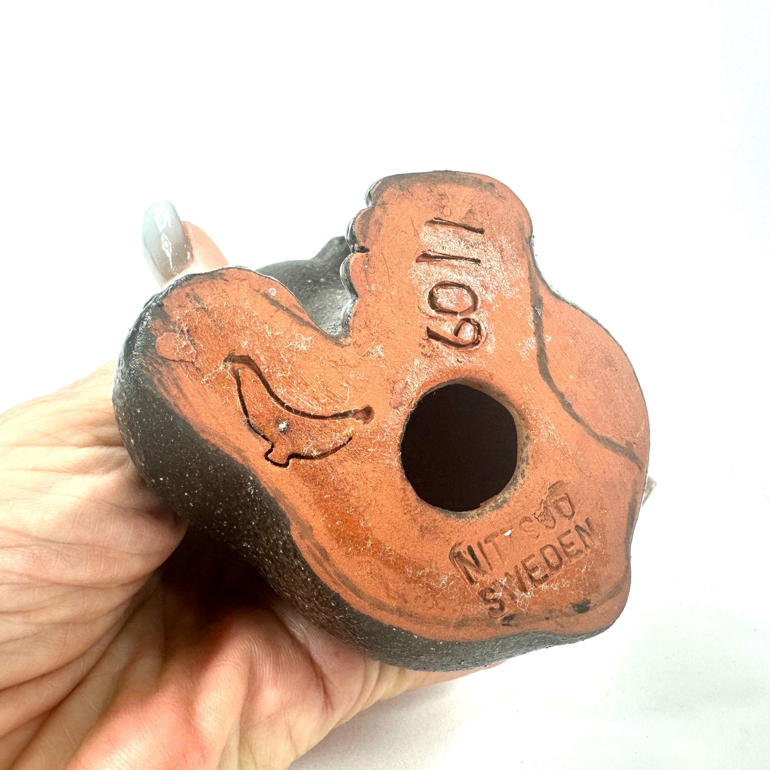 Nittsjö ceramic bear base detail in terracotta showing maker mark, numbering, and artist signature carved into clay