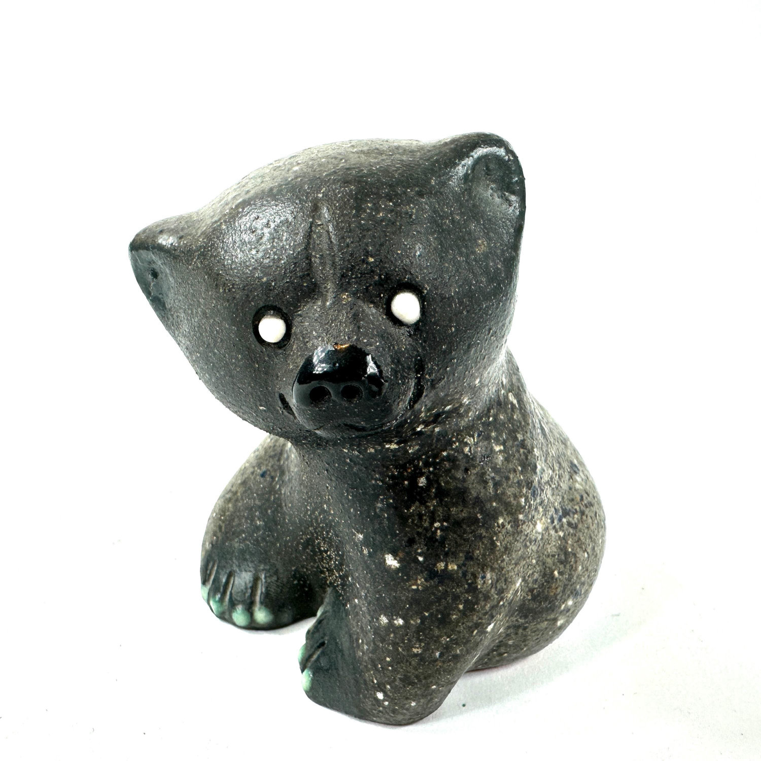 Seated ceramic bear in mottled gray-green glaze, front three-quarter angle showing rounded body and articulated paw details