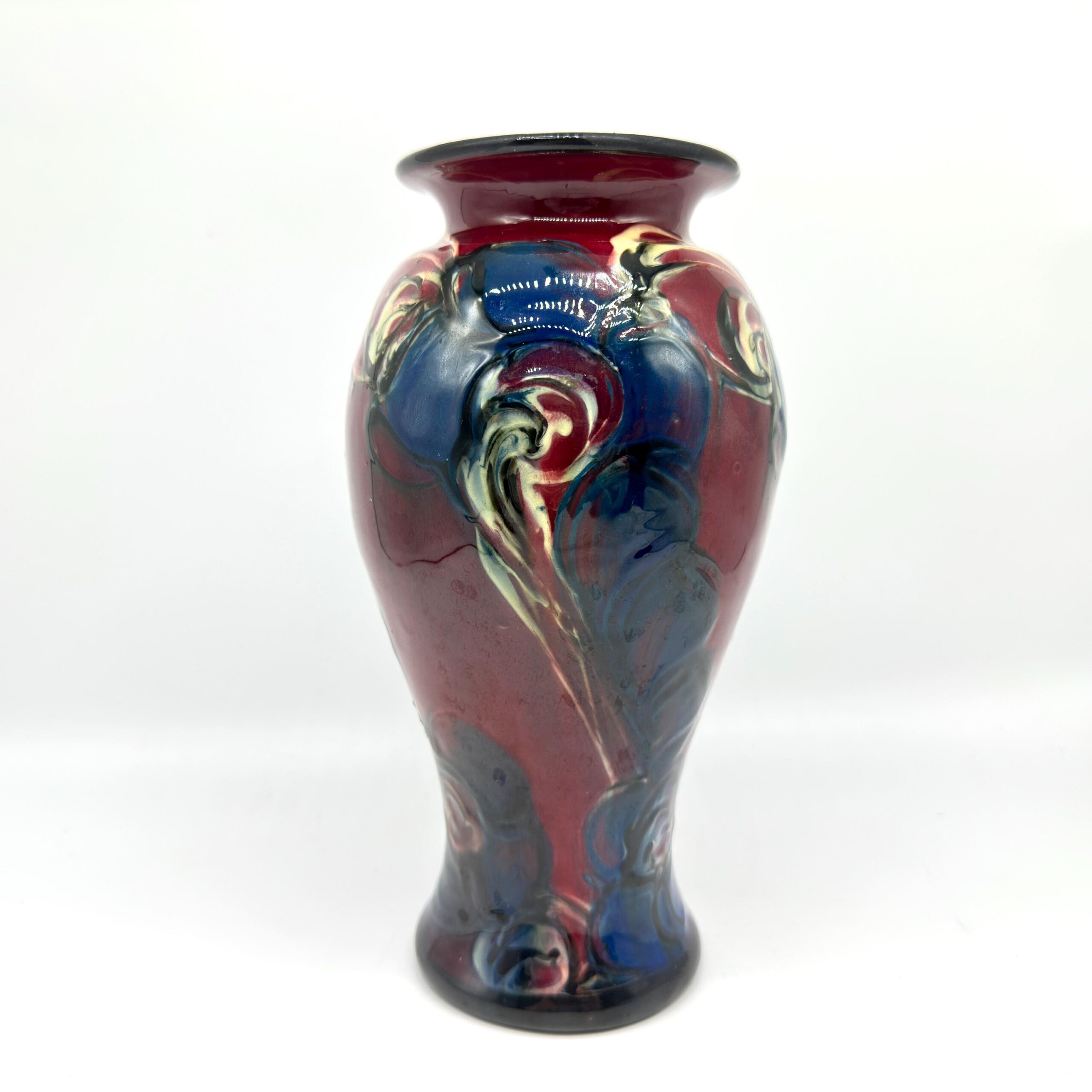 Side view of red blue Danico vase showing curved silhouette and glaze flow patterns along the form