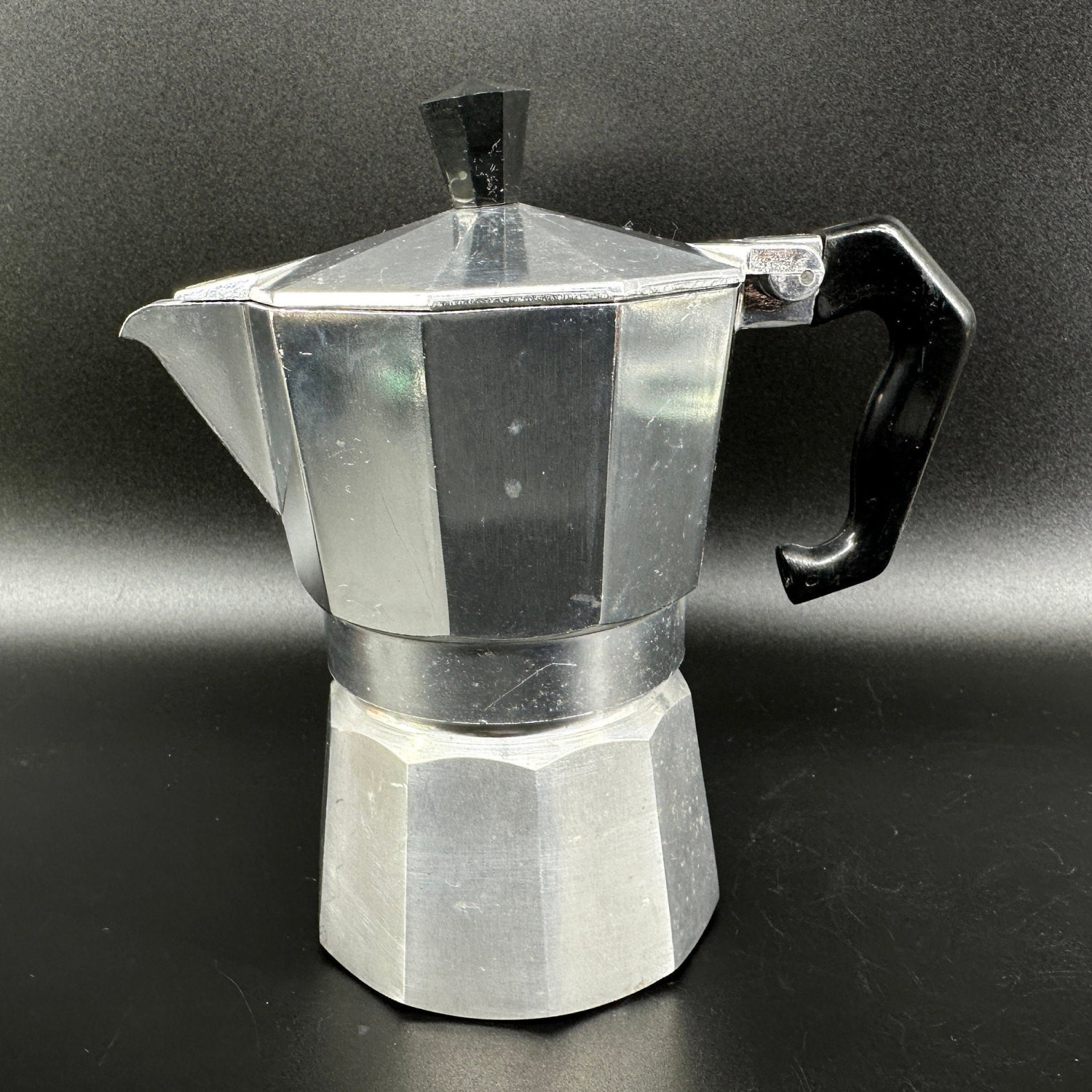 Three-quarter angle view of vintage moka pot revealing spout, handle positioning, and overall silhouette