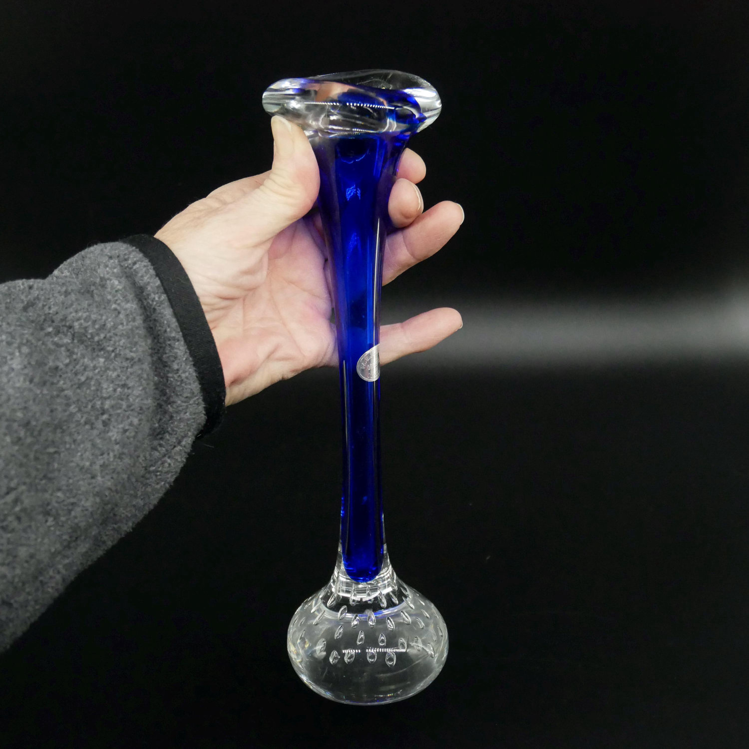 Vintage Orrefors blue hand-blown glass bud vase from 1960s, held in hand showing full silhouette with bubble detail base