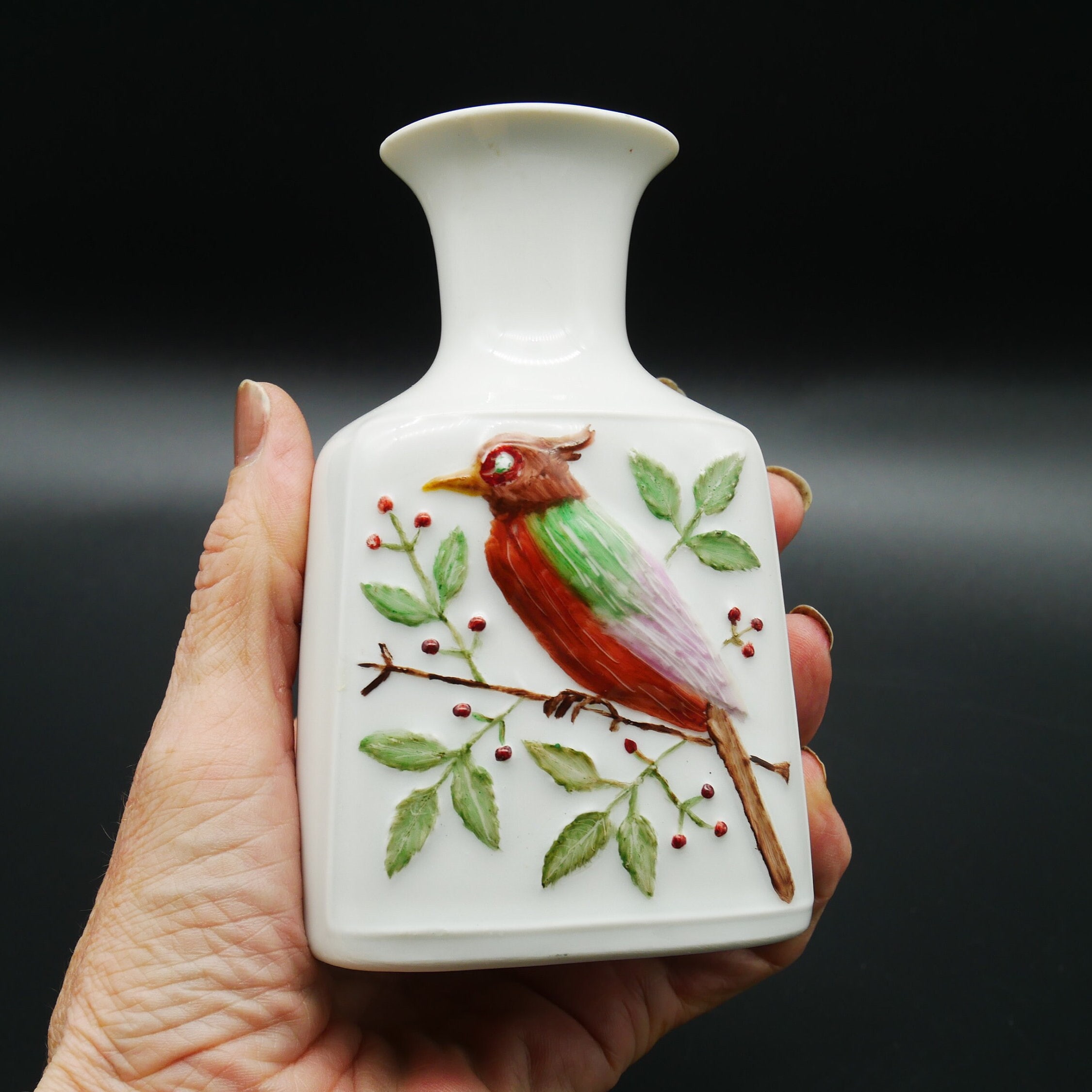 Wunsiedel Bavaria porcelain vase held in hand, cream white with hand-painted cardinal and leafy branches, signed RL-78