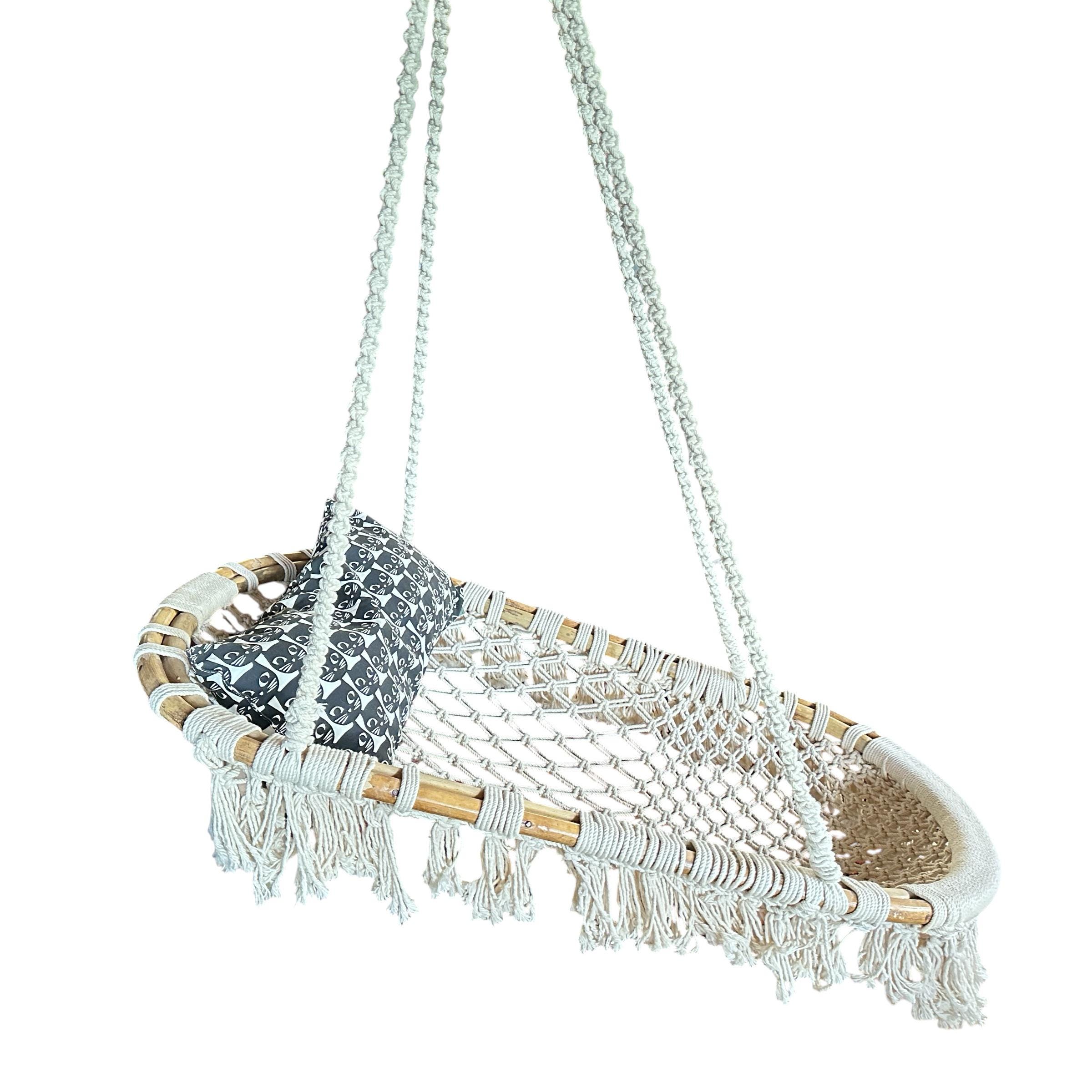 Angled perspective of vintage macramé hammock chair showing seat depth, bamboo frame construction, and decorative fringe