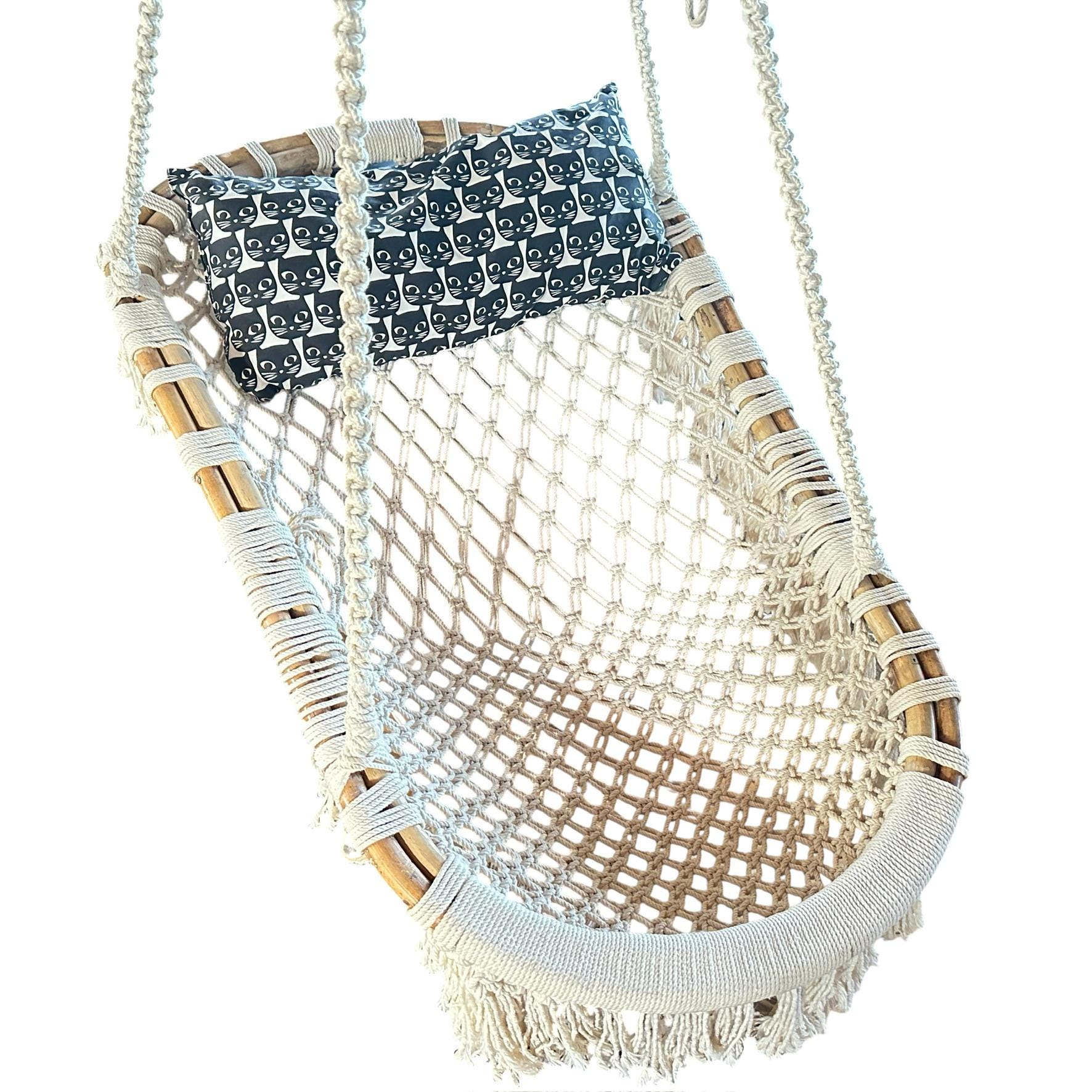 Overhead view of macramé hanging chair showing navy and cream woven pattern with bamboo frame and fringe trim detail