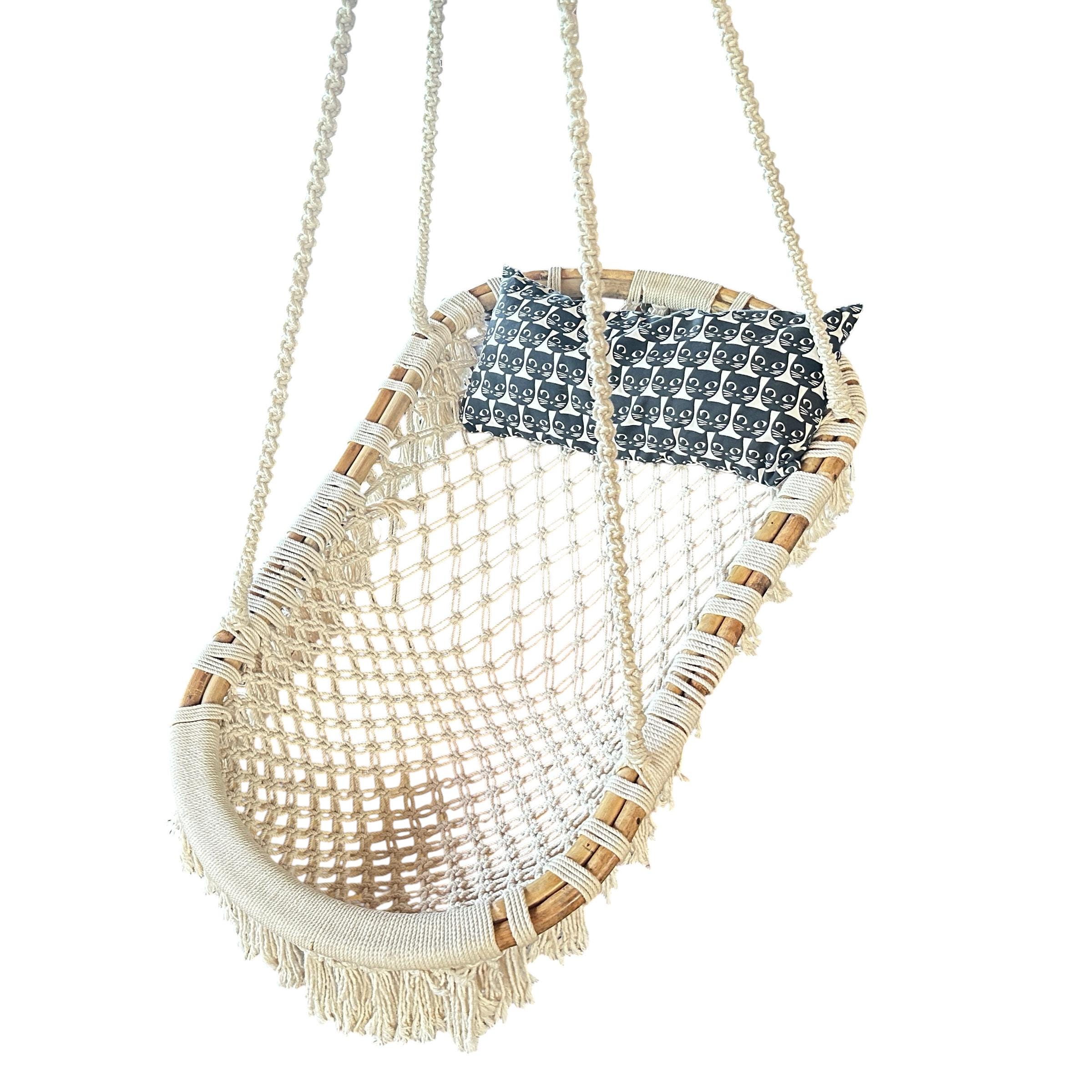 Side angle view of vintage macramé swing chair displaying natural rope suspension and textured woven seat construction