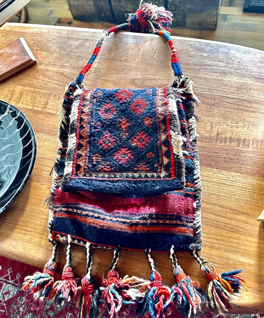Traditional Swedish woven textile bag with geometric diamond pattern in deep indigo and burgundy red, featuring braided fring