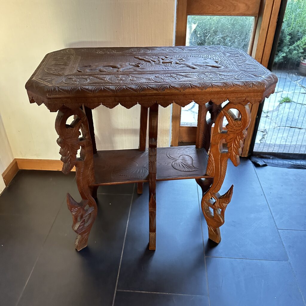 Anglo-Indian carved wooden table with ornamental legs and filigree details on the top surface